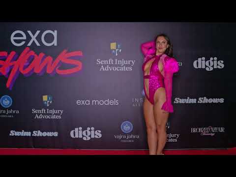 Model poses for photographer on the red carpet at Exa Shows Art Basel Miami